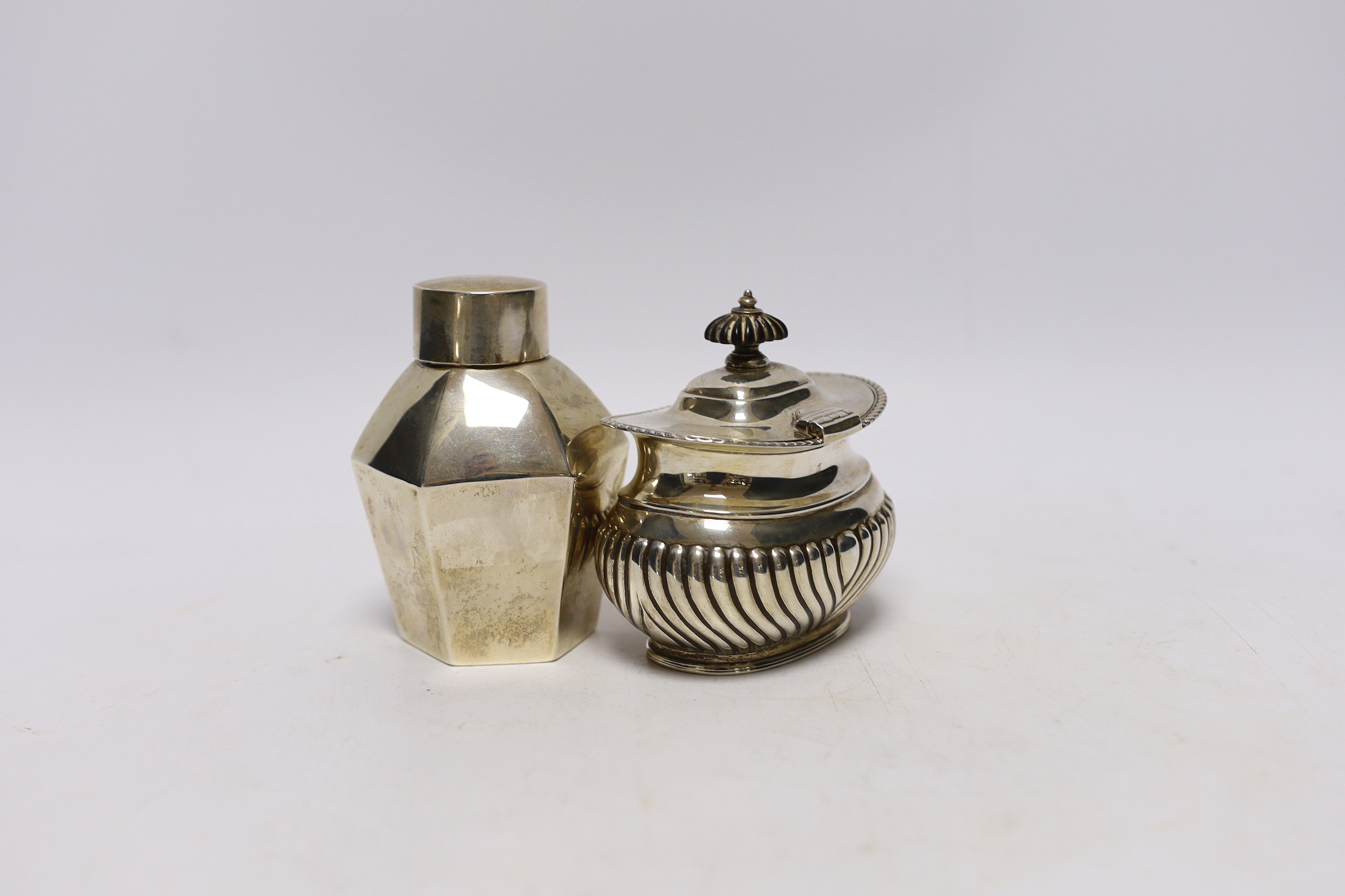 An Edwardian silver hexagonal tea caddy, by Nathan & Hayes, Chester, 1908, 97mm and one other demi-fluted silver tea caddy, George Howson, London, 1912.